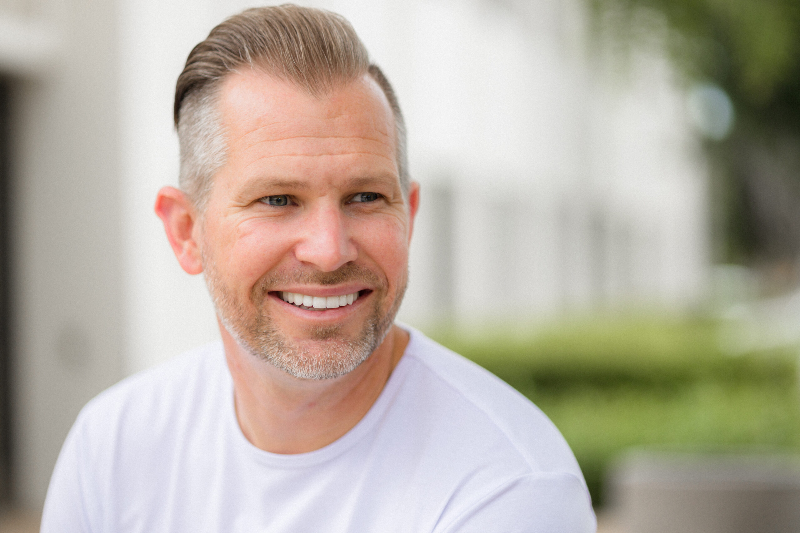 Satisfied patient smiling after receiving porcelain veneers from Dr. Hales in Orange County.